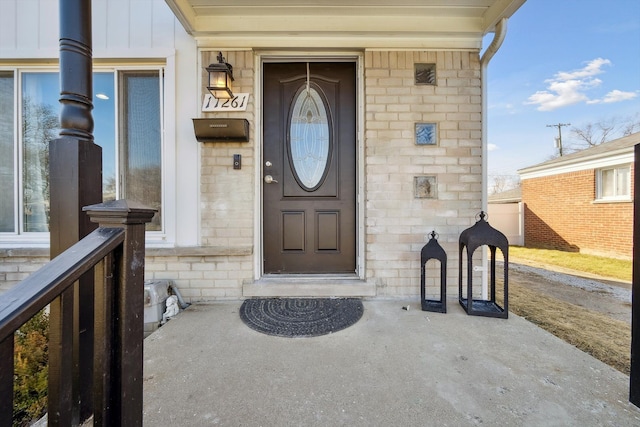 entrance to property with board and batten siding and brick siding