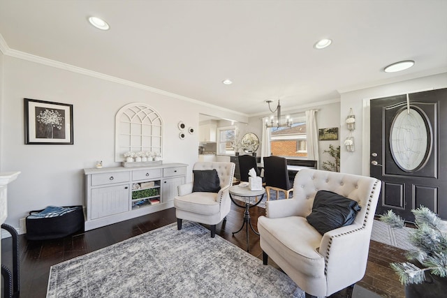 living room with a notable chandelier, ornamental molding, dark wood finished floors, and recessed lighting