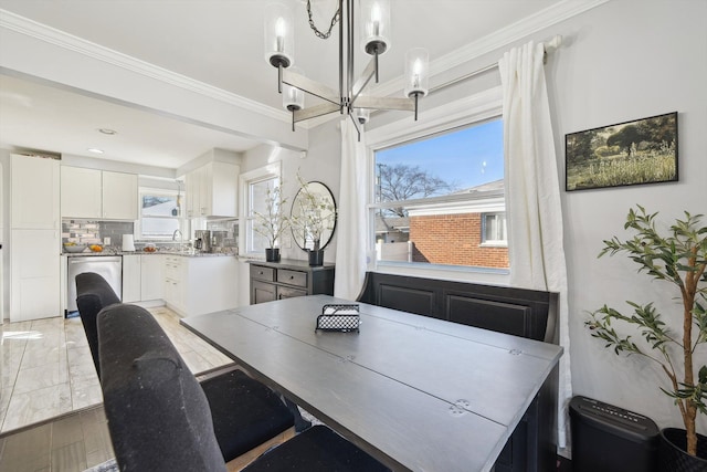 dining space featuring ornamental molding and a chandelier