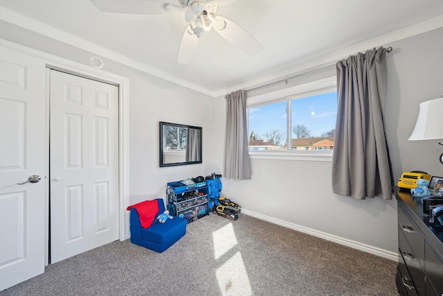 interior space featuring a ceiling fan, crown molding, baseboards, and carpet flooring