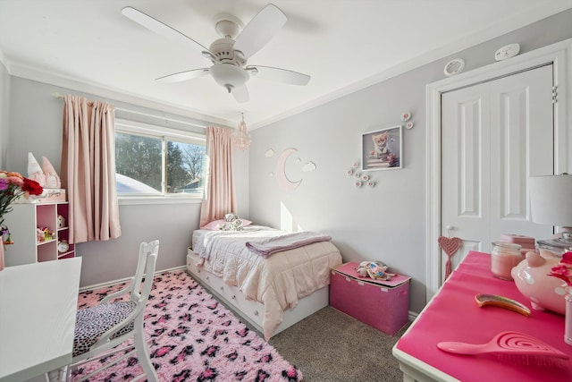 carpeted bedroom with ceiling fan, baseboards, and crown molding