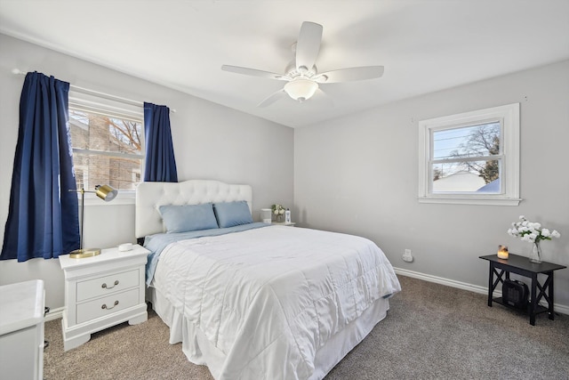 bedroom featuring carpet, multiple windows, baseboards, and a ceiling fan