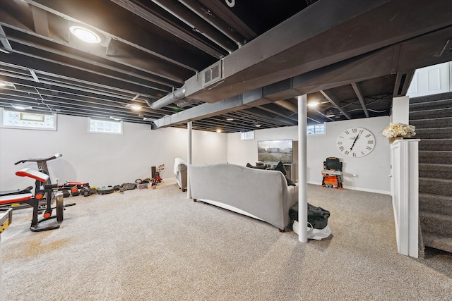 basement with visible vents, stairway, and carpet flooring