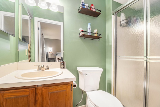 full bathroom featuring toilet, an enclosed shower, and vanity