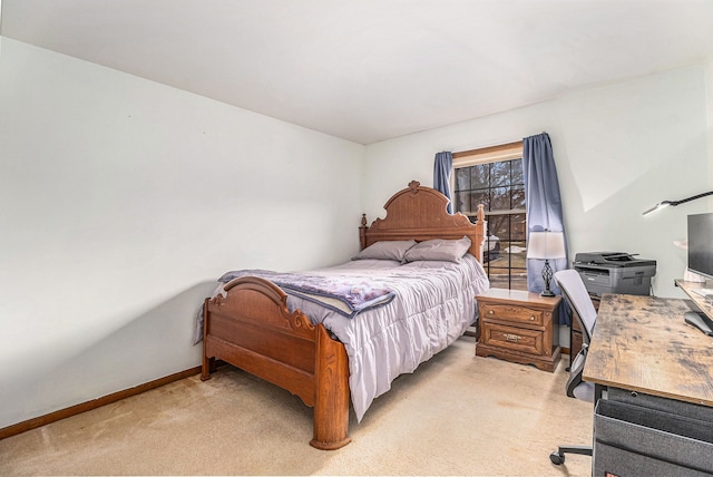 bedroom featuring baseboards and light colored carpet