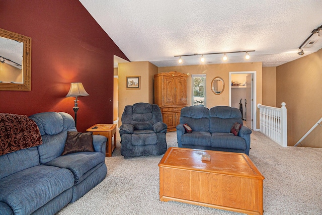 carpeted living area featuring rail lighting, visible vents, vaulted ceiling, and a textured ceiling