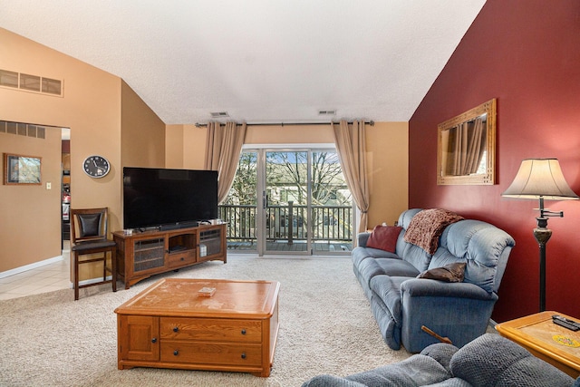 carpeted living area with lofted ceiling and visible vents