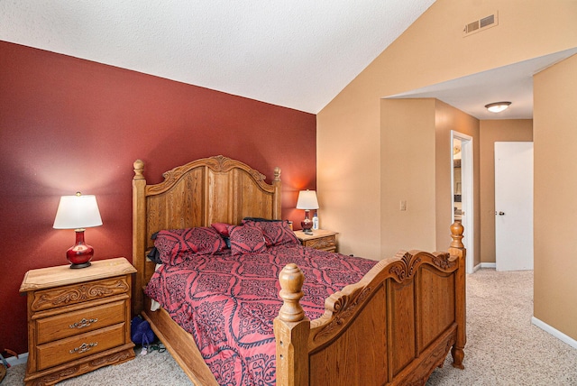 bedroom with visible vents, vaulted ceiling, light carpet, and baseboards