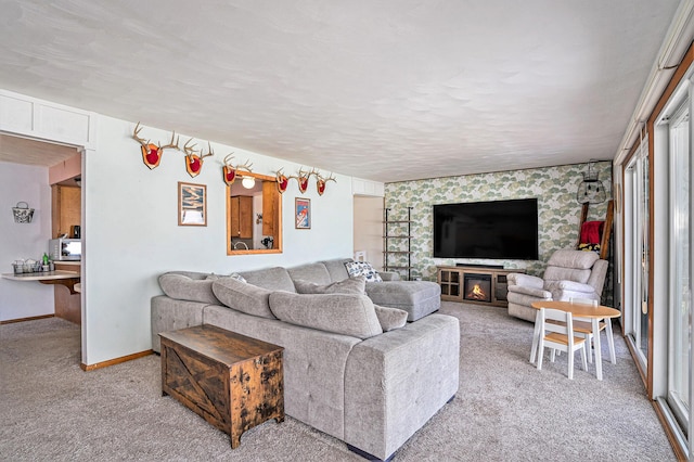 living area featuring light carpet, a textured ceiling, and baseboards