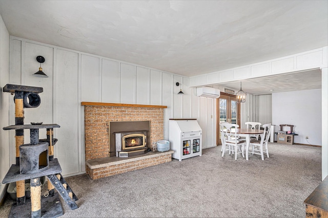 living area with an AC wall unit, carpet flooring, and a wood stove