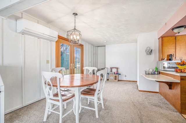 dining area featuring french doors, light colored carpet, an inviting chandelier, a wall mounted AC, and baseboards