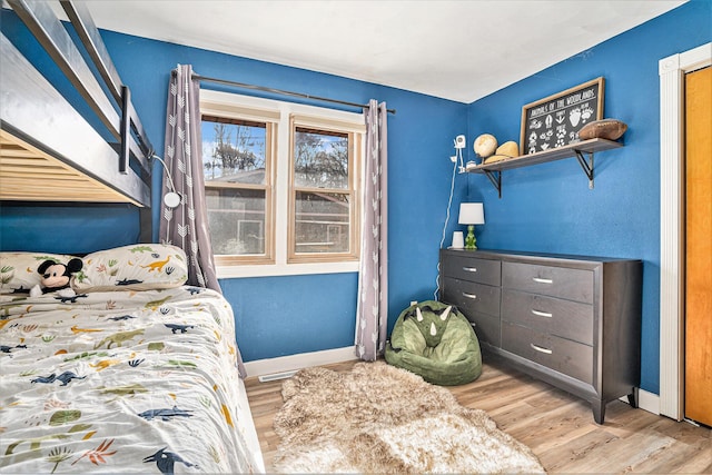 bedroom featuring baseboards and wood finished floors