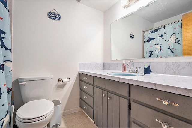 full bathroom with tile patterned flooring, baseboards, vanity, and toilet