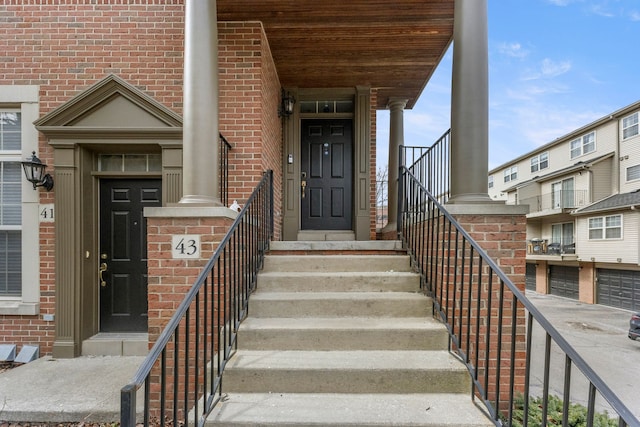 view of exterior entry with brick siding