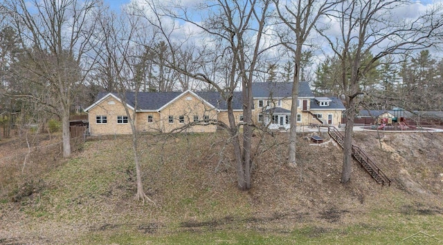 view of front of property featuring stairs and stone siding