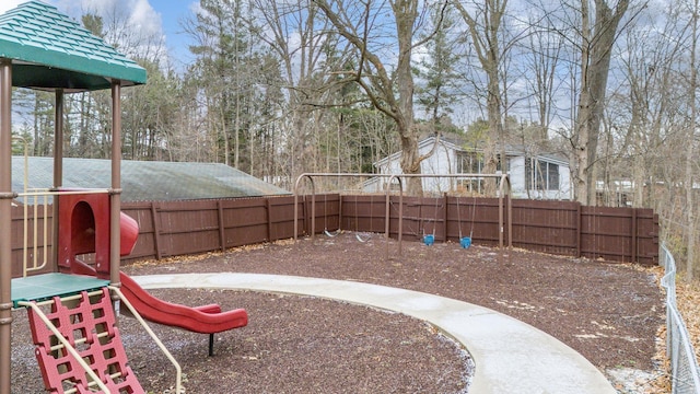 view of yard with a fenced backyard and a playground