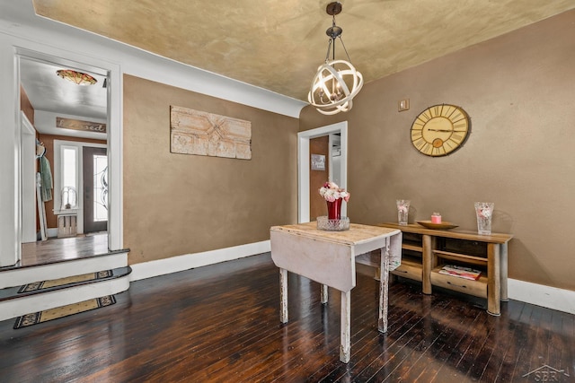 dining space with wood-type flooring, baseboards, and a notable chandelier