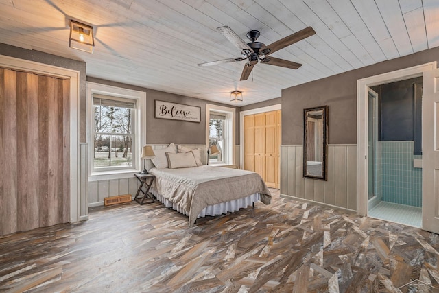 bedroom with wooden ceiling, wainscoting, wood finished floors, and visible vents