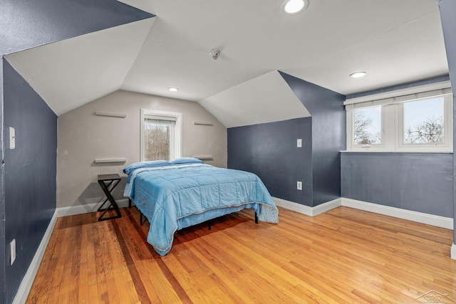 bedroom featuring baseboards, recessed lighting, wood finished floors, and lofted ceiling