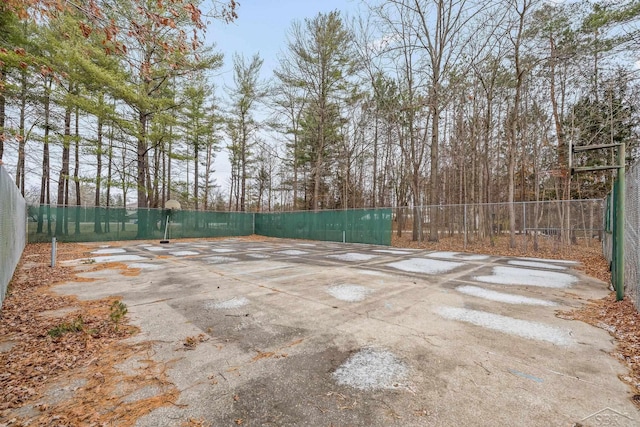 view of basketball court with fence