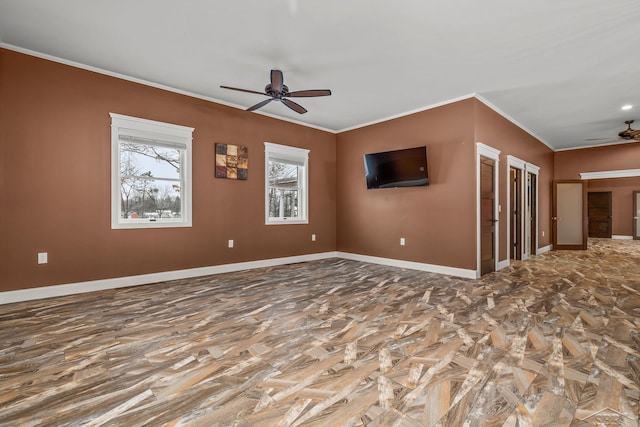 empty room with ornamental molding, ceiling fan, and baseboards