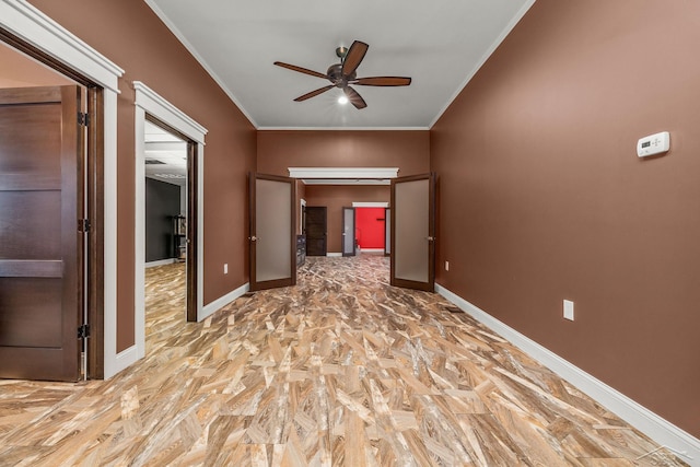 unfurnished bedroom with crown molding, baseboards, and ceiling fan