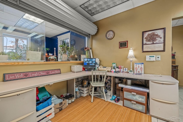 office area with wood finished floors and a paneled ceiling