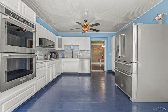 kitchen with stainless steel appliances, ceiling fan, tasteful backsplash, light countertops, and white cabinets
