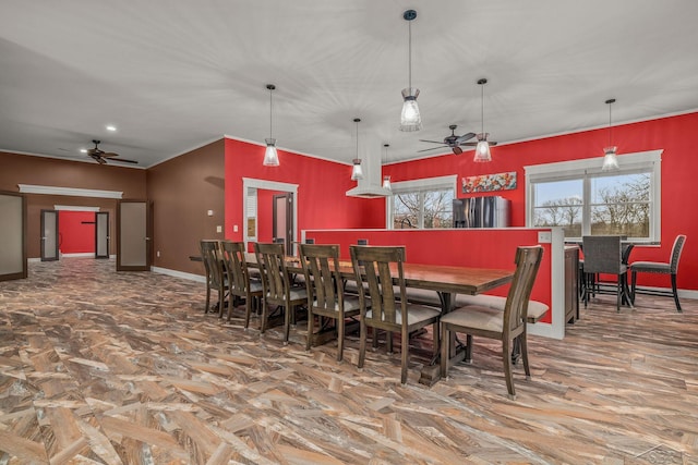dining area with baseboards, ornamental molding, and a ceiling fan