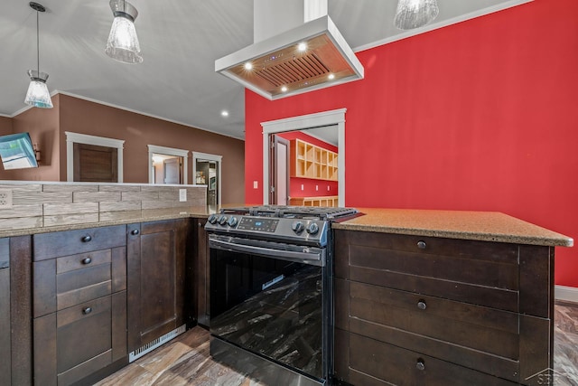 kitchen with light stone countertops, wall chimney range hood, dark brown cabinets, ornamental molding, and stainless steel gas range