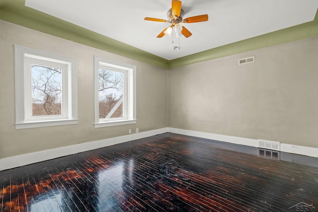 unfurnished room with a ceiling fan, baseboards, visible vents, and dark wood-style flooring