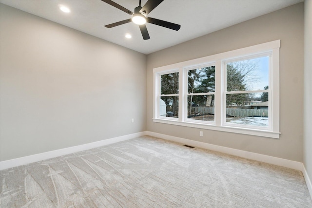 empty room featuring light carpet, visible vents, baseboards, a ceiling fan, and recessed lighting