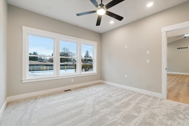 unfurnished room with carpet, recessed lighting, visible vents, and baseboards