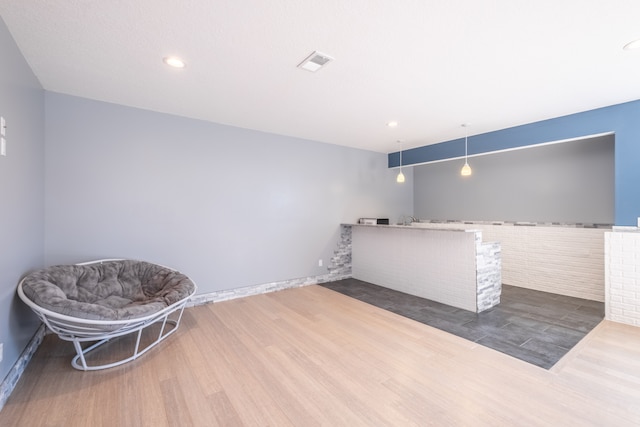 sitting room with recessed lighting, wood finished floors, and visible vents