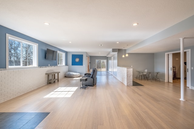 living area with recessed lighting and wood finished floors