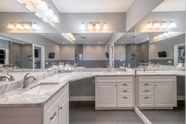 full bathroom with a sink, double vanity, and tile patterned floors