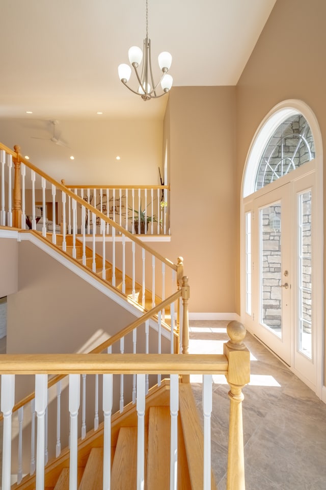 stairs featuring a notable chandelier