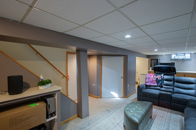 living room with a paneled ceiling, light carpet, baseboards, and recessed lighting