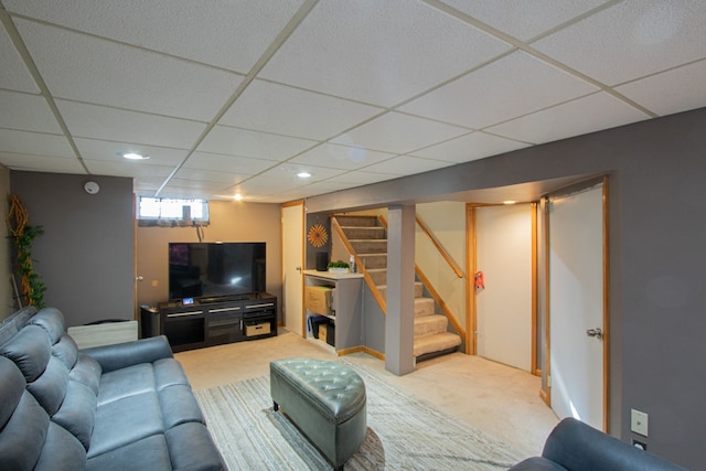 living room with carpet, stairs, a drop ceiling, and recessed lighting