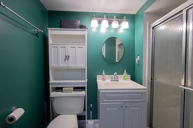 bathroom featuring a shower stall, toilet, and vanity