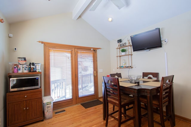 dining area with lofted ceiling with beams, light wood-style floors, baseboards, and visible vents