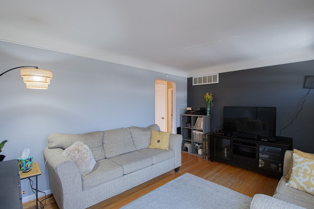 living room with visible vents and wood finished floors