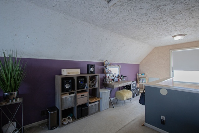 interior space with lofted ceiling, baseboards, carpet floors, and a textured ceiling