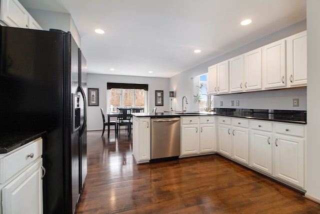 kitchen featuring black fridge, a sink, plenty of natural light, a peninsula, and dishwasher