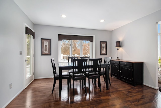 dining room with dark wood-type flooring, recessed lighting, and baseboards