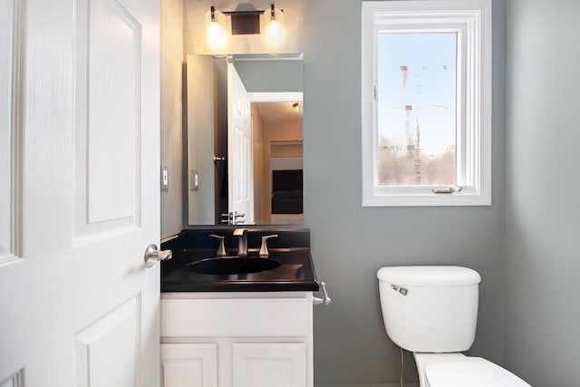 bathroom featuring toilet and vanity