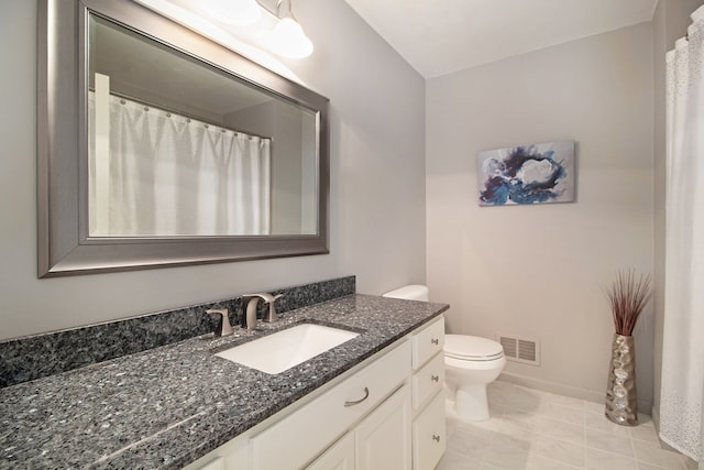 bathroom with vanity, toilet, baseboards, and visible vents