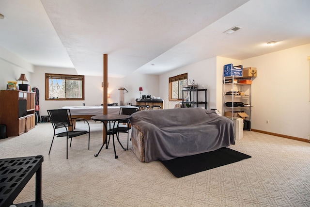 living area with light colored carpet, visible vents, and baseboards