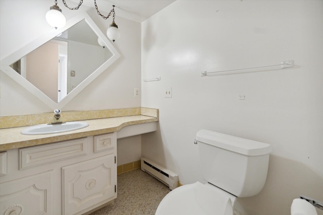 bathroom featuring toilet, vanity, and baseboard heating