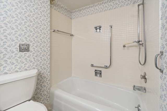 bathroom with  shower combination, toilet, and wallpapered walls